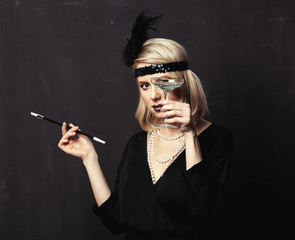 Poster - Beautiful blonde woman in twenties years clothes with smoking pipe and cocktail on dark background