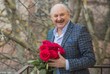 © T.Den_Team - Older happy Senior man with a bouquet of flowers waiting on a date. Mature people lifestyle