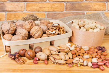Wall Mural - Various shelled and unpeeled nuts on the wooden surface