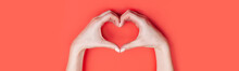 Female Hands Show A Heart Symbol On A Red Background. Place For Text, Copy Space, Banner Format