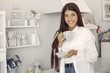 © prostooleh - Woman in the kitchen. Lady in a white shirt. Girl drinking a coffee