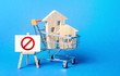 © Andrii Yalanskyi - Houses in a shopping cart and easel red prohibition sign NO. Inaccessibility, lack housing, deficit. Seizure, freezing of assets by a bank, court. Expensive maintenance, impossibility of restoration