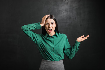 Sticker - Stressed female teacher near blackboard in classroom