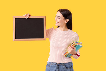 Wall Mural - Female teacher with chalkboard on color background