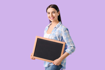 Wall Mural - Young woman with chalkboard on color background