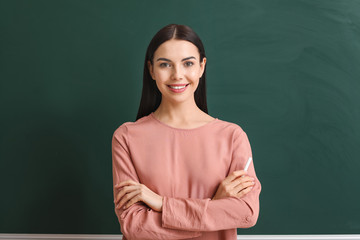 Poster - Female teacher near blackboard in classroom