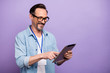 © deagreez - Portrait of confident cool brunet hair man worker use tablet search offers he bring on corporate meeting have template badge name tag wear stylish outfit isolated purple color background