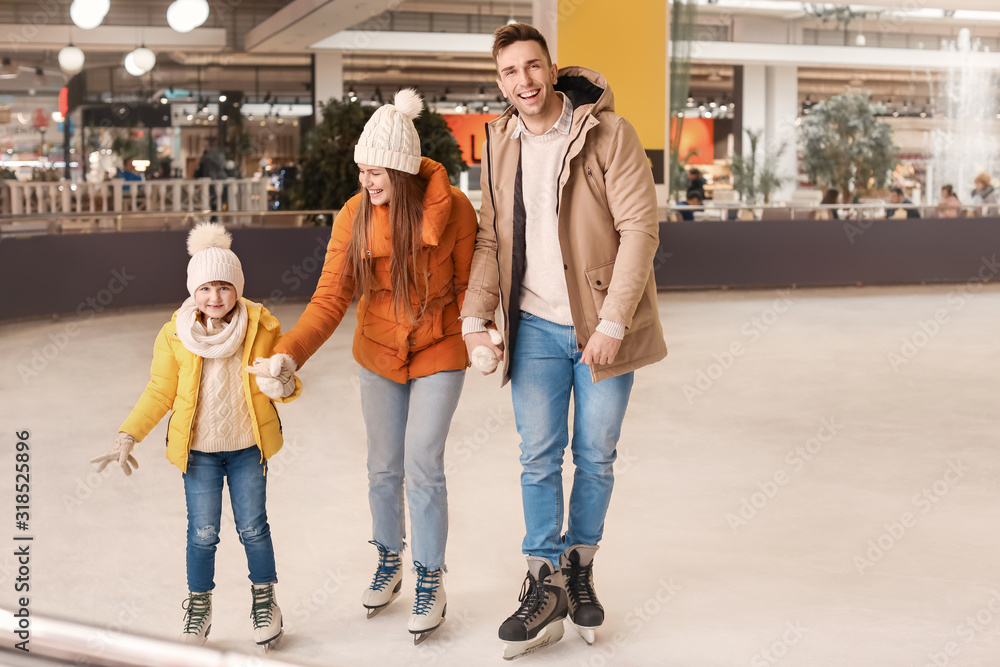 Happy family on skating rink