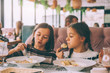 Children eat pasta in family cafe