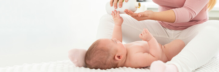 baby massage banner with copy space. kids therapist applying massage oil to baby boy. mother massagi