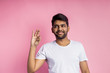 © liliyabatyrova - Portrait of handsome Indian guy standing on pink background