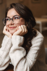 Sticker - Image of young caucasian woman wearing eyeglasses smiling in cafe