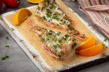 Canvas Print - Grilled whole fish (perch, sea bass, redfish) with parsley and lemon (orange), delicious roasted food. Healthy