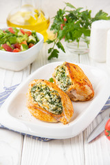 Wall Mural - Chicken fillet stuffed with cottage cheese (ricotta, feta) and herbs (parsley, spinach, dill). Delicious homemade food, healthy