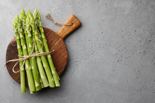 Bunch Of Green Asparagus On Concrete Background