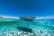 Tropical Turquoise Ocean Water With Sandy Bottom Underwater And Boat