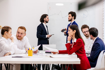 Wall Mural - young business co-workers in office, discuss ideas and projects together with partners in modern office, successful interaction of diverse partners