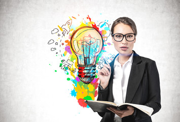 businesswoman with notebook and her bright idea