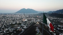 Mexican Flag In City Against Clear Sky During Sunrise