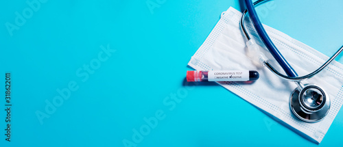 2019-nCoV  in Wuhan, China. virus Coronavirus blood test in Laboratory Coronavirus test list medical form, test blood tubes stethoscope on blue copy space background for a banner.