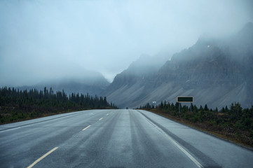 Scenic road trip with rocky mountain in gloomy day at Banff national park