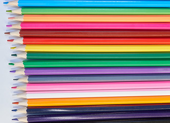 Close up color pencils and white notepad paper background with a color gradient. school concept top view. full screen pencils wallpaper