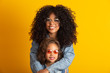 © Brastock Images - Afro mother and daughter with their glasses. Mother's day concept
