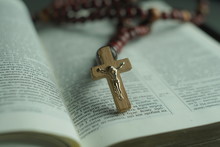Opened Bible And Wooden Rosary