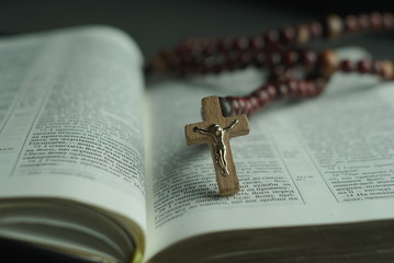 opened bible and wooden rosary