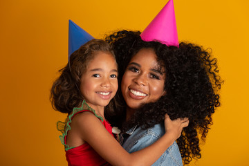 Afro daughter and mother are happy together.