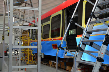 Wall Mural - Inside of the rail car assembly plant. Industrial workshop for the production of high speed trains. Factory of the manufacturing trainsets passenger rolling stock. Paint shop. Small sharpness.