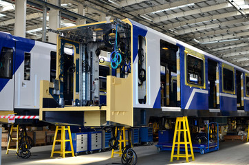 Inside of the rail car assembly plant. Industrial workshop for the production of European high speed trains. Factory of the manufacturing trainsets rolling stock for subway - Image