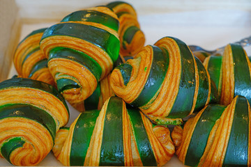 Wall Mural - Freshly baked French croissants with green sugar icing