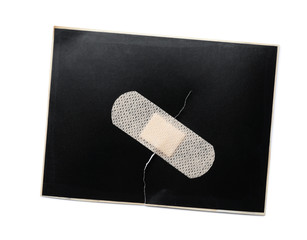 black paper sheet with sticking plaster isolated on white, top view