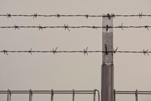 Barbed Wire Fence Against Sky