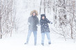 © satura_ - Young couple playing with snow in winter park