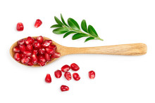 Pomegranate Seeds In Wooden Spoon Isolated On White Background With Clipping Path And Full Depth Of Field. Top View. Flat Lay.