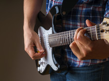Midsection Of Man Playing Guitar