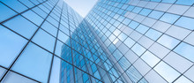 Glass Facades Of Modern Office Buildings And Reflection Of Blue Sky