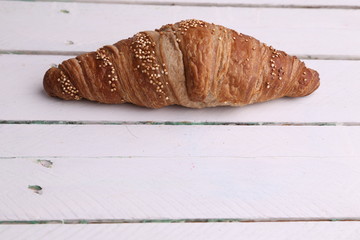 delicious spelled croissant in color background