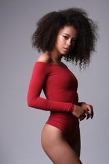 Beautiful afro-american model posing in red body.