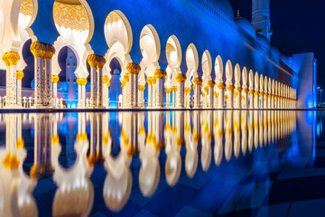 Reflections in water of the walkway inside the Sheikh Zayed Mosque or the Grand Mosque during evening