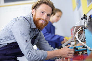 man during assembly of electronic components