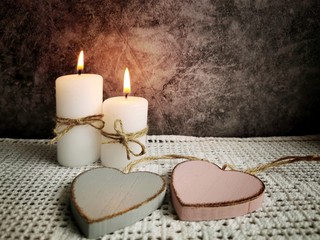 Wall Mural - Two hearts and two candles on a dark background. Valentine's Day concept. 