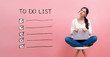 © Tierney - To do list with young woman using a laptop computer
