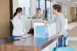© auremar - man with suitcase standing at reception in hotel