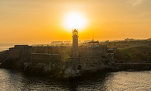 The Sun Is Rising Over El Morro Castle And Lighthouse In Cuba