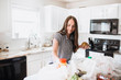 © MeganBetteridge - Lifestyle of women unloading her groceries at home in a white kitchen