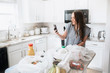 © MeganBetteridge - Lifestyle of women unloading her groceries at home in a white kitchen