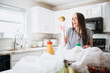 © MeganBetteridge - Lifestyle of women unloading her groceries at home in a white kitchen